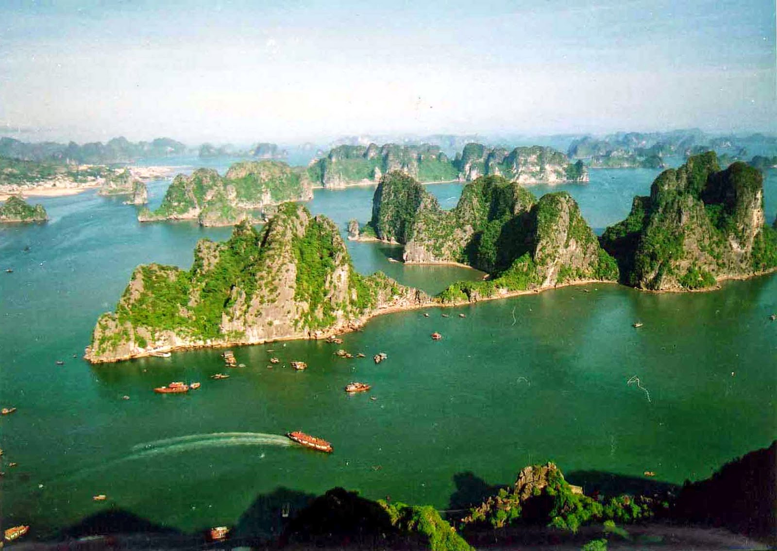 Limestone pillars rising out of the emerald-green waters of Ha Long Bay